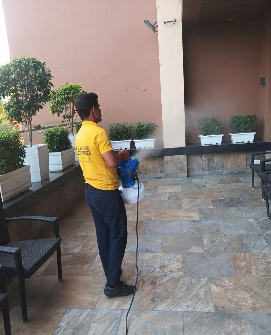 Safe Home technician treating the entrance perimeter of a hotel