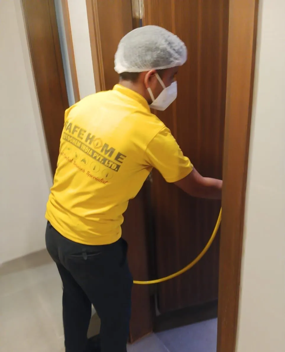 Safe Home technician treating a corridor doorway