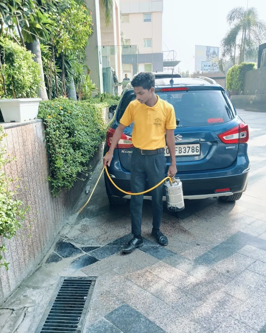 Safe Home Pestochem technician: treating drains and paving around a building
