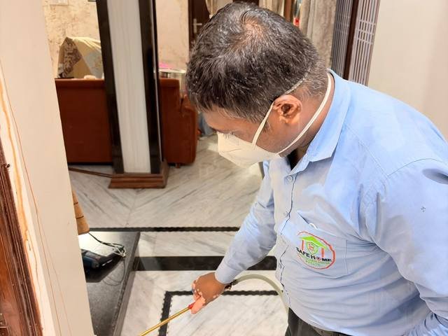 Post-construction termite treatment along an internal floor junction